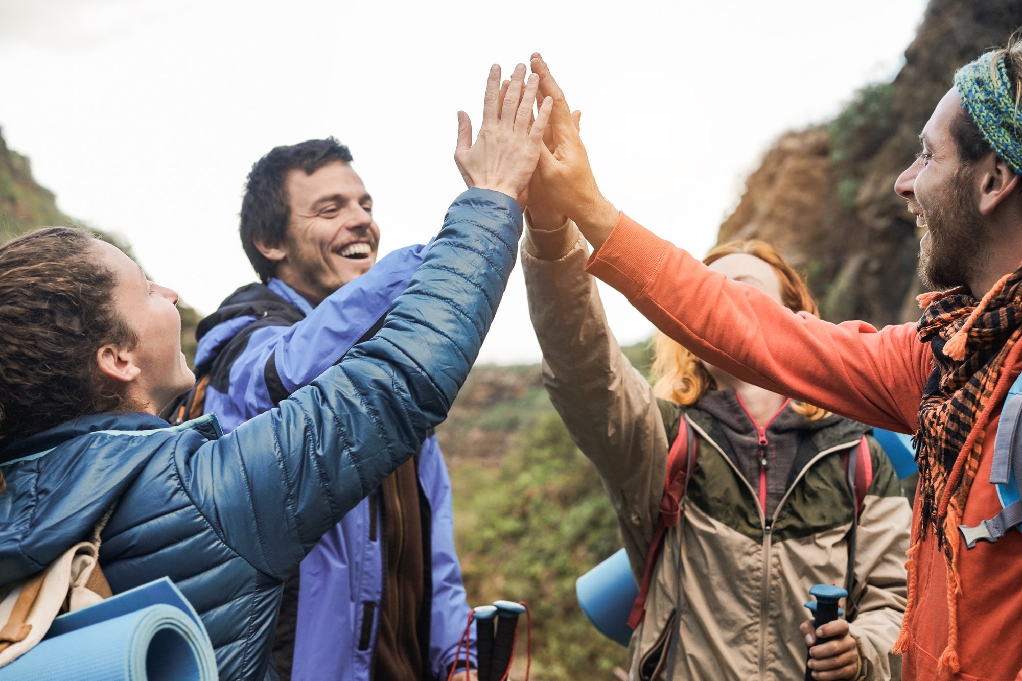 group-of-happy-trekkers-stacking-hands-outdoor-main-focus-on-hands.jpg